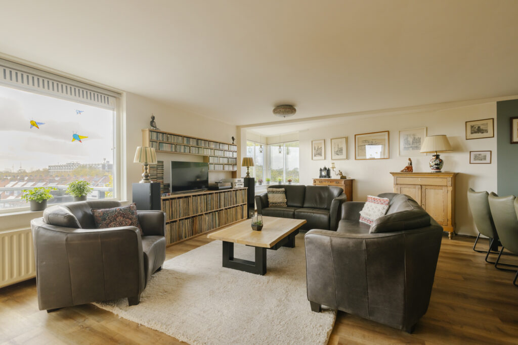 Cozy living room with leather sofas and wooden furniture.