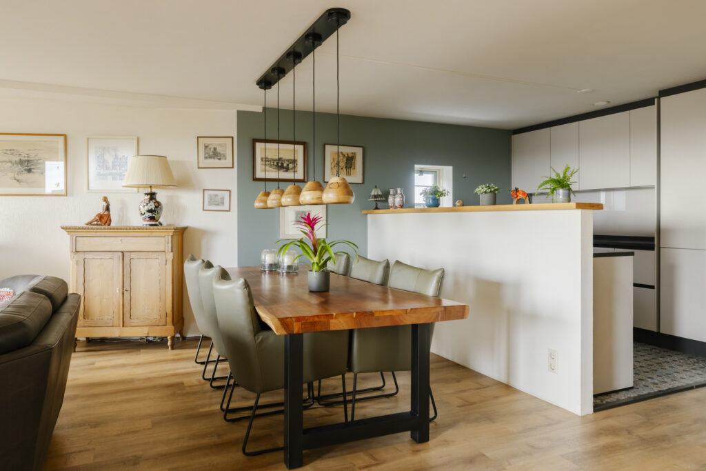 Modern dining room with wooden table and chairs.