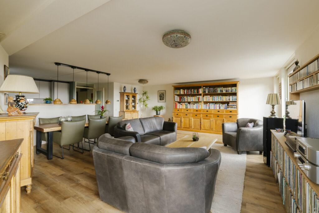 Spacious living room with bookshelves and seating.