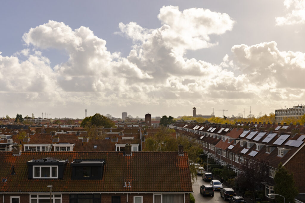 Sunny suburban neighborhood under cloudy sky
