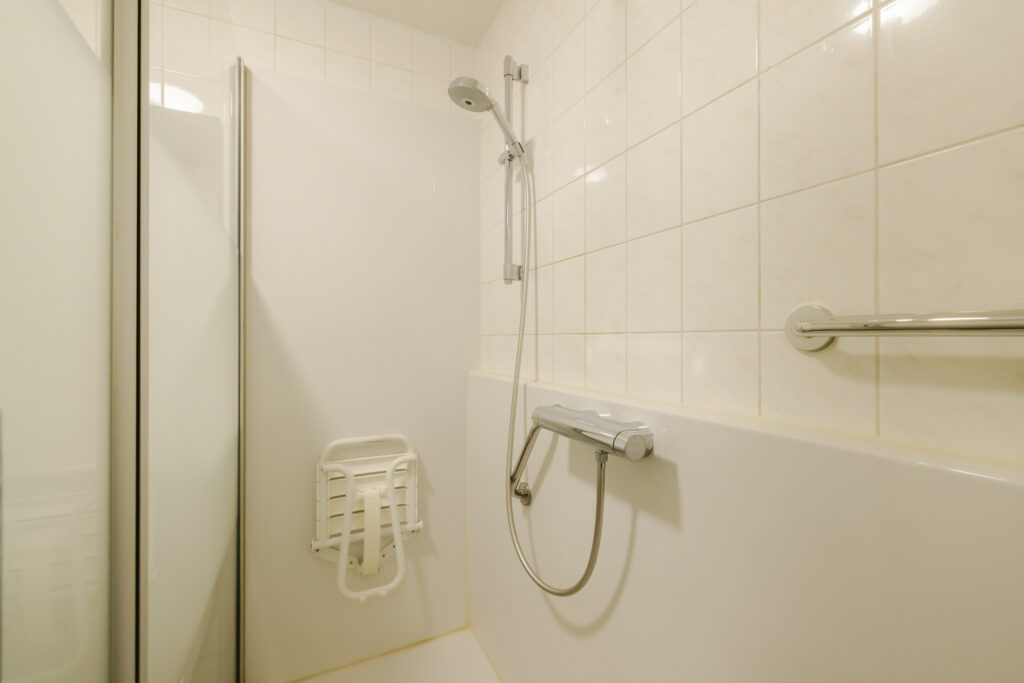 Accessible shower with grab bars and seat