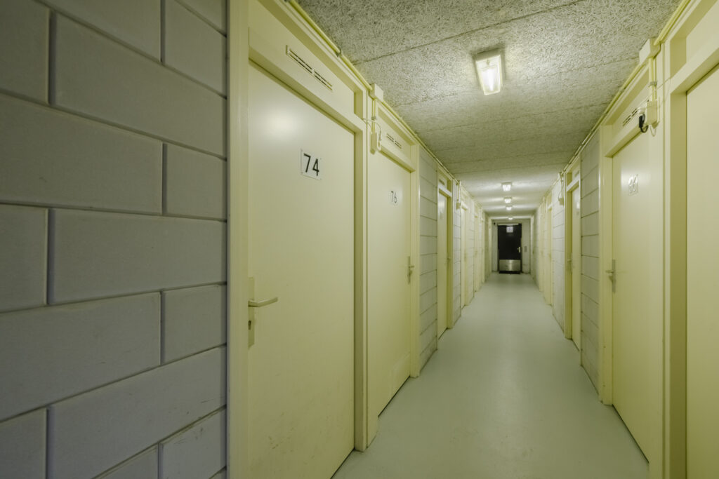 Empty corridor with numbered storage doors