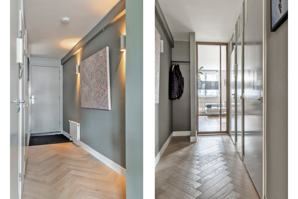 Modern hallway with wood flooring and artwork.