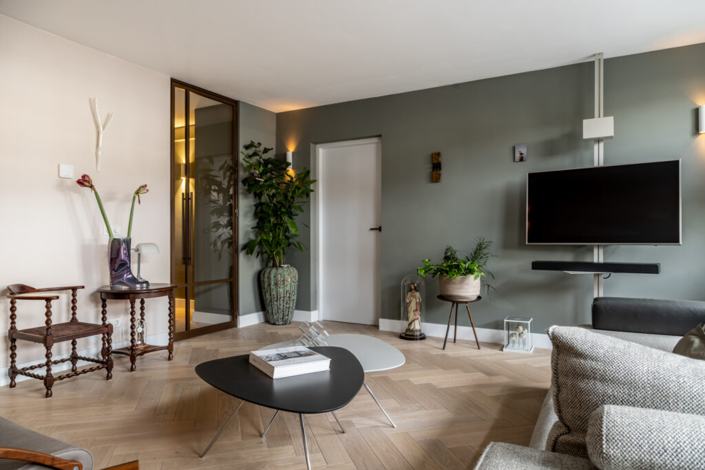 Modern living room with plants and dark wood furniture.