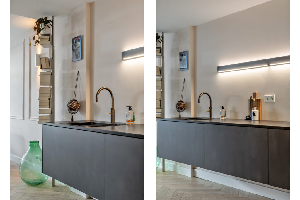 Modern kitchen with wall-mounted books and green vase.