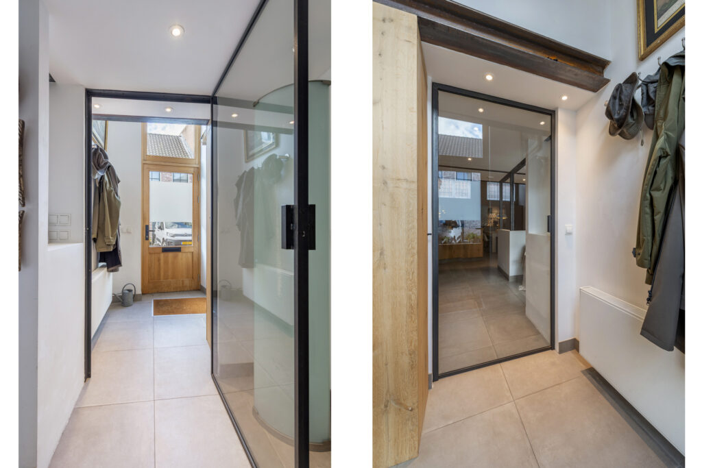 Modern entrance with glass doors and coat hangers.