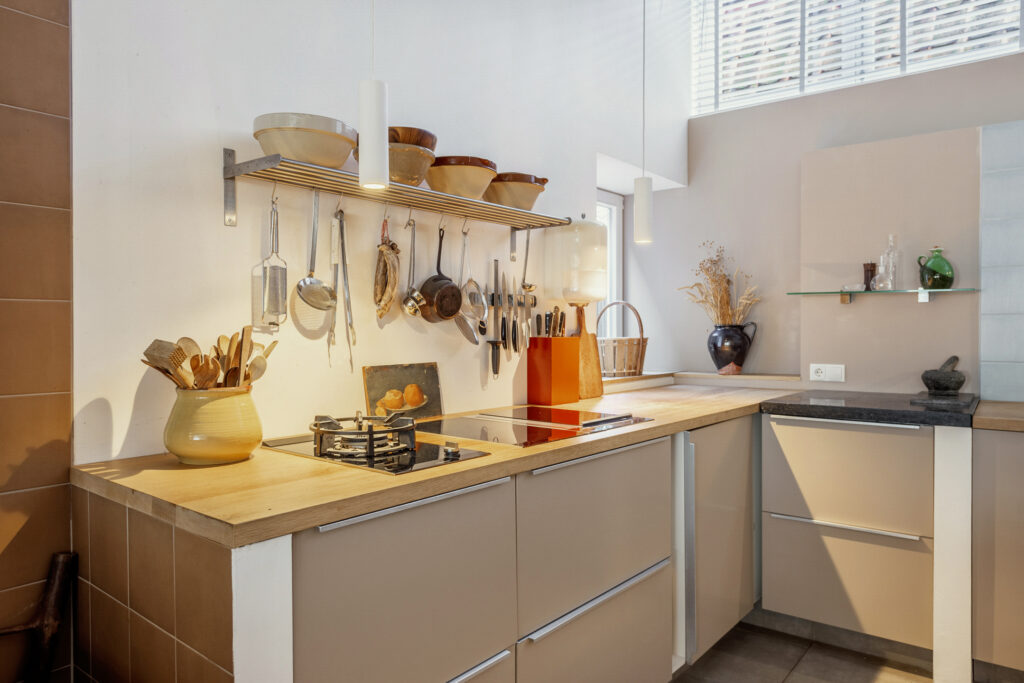 Modern kitchen with utensils and hanging plants