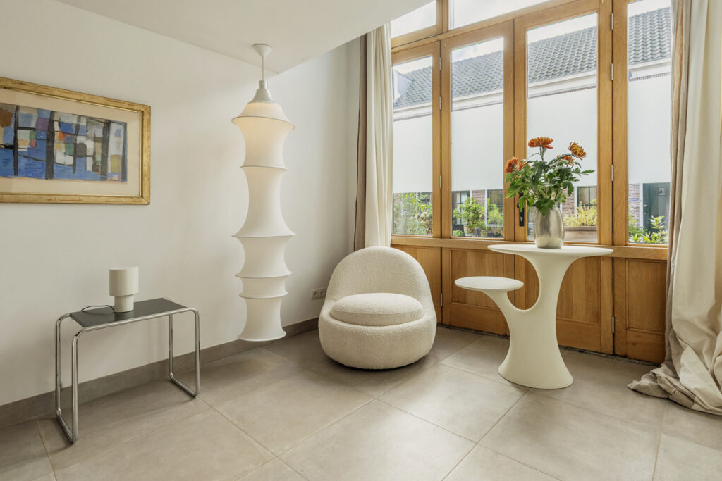 Modern living room with chair and table by window.