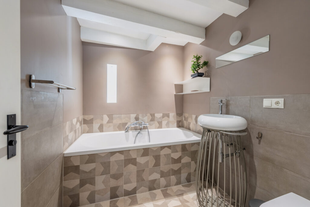 Modern bathroom with tub and stylish decor