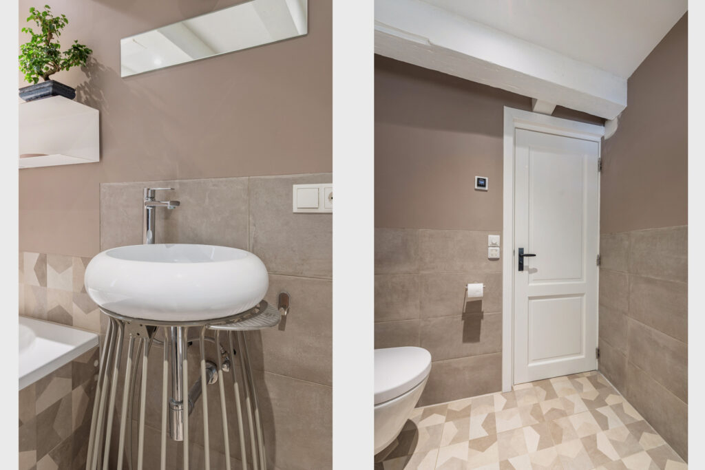 Modern bathroom with geometric tiles and sleek fixtures.