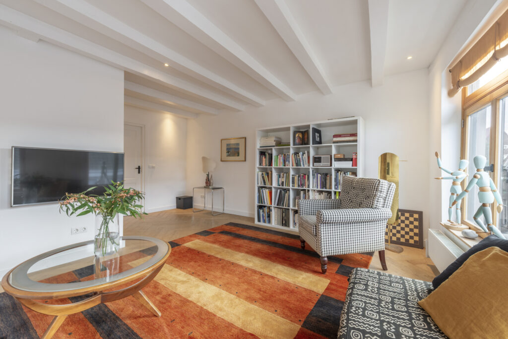 Cozy living room with bookshelves and patterned chair.