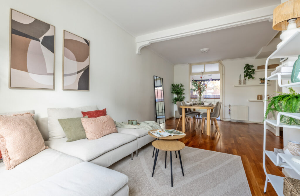 Bright living room with modern decor and dining area.