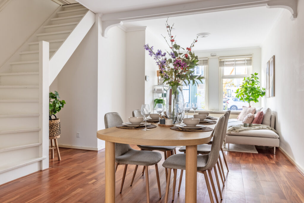 Cozy dining room with table and decor flowers.