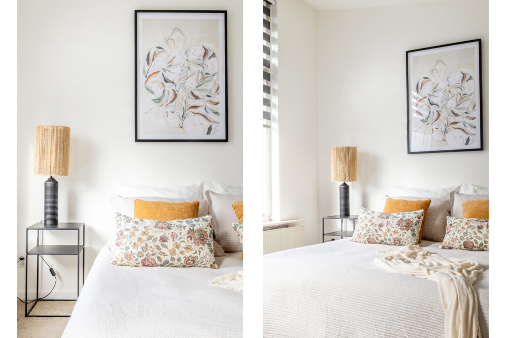 Cozy bedroom with floral pillows and artwork.