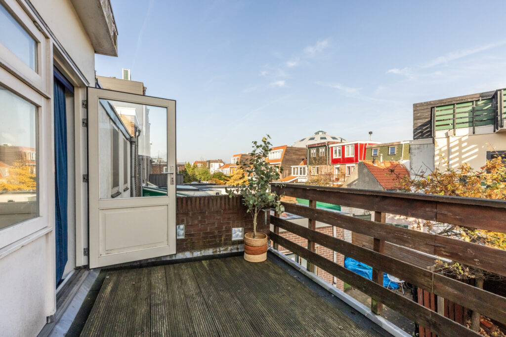 Rooftop terrace with city view and open door