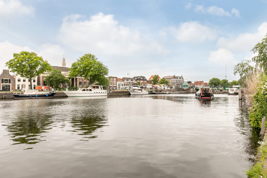 Canal with boats and buildings on a sunny day.