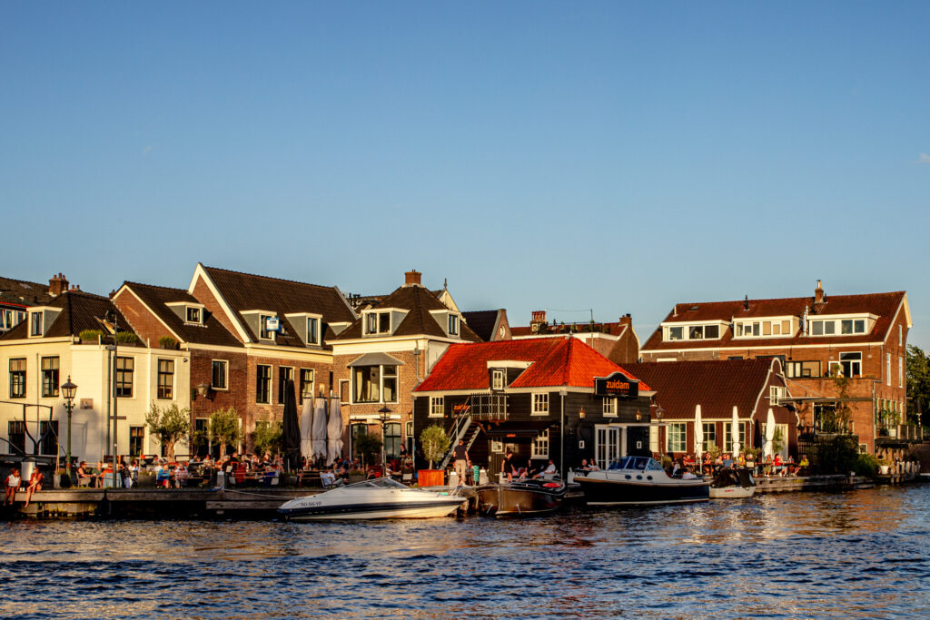 Riverside houses with boats during sunset