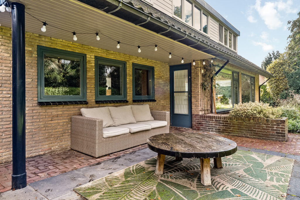 Cozy patio with sofa and round table.