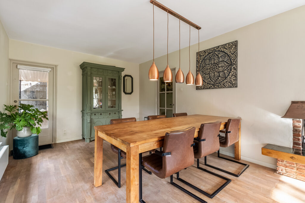 Modern dining room with wooden table and chairs.