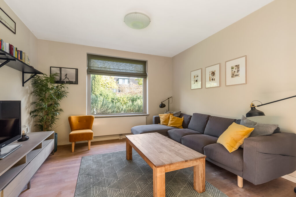 Modern living room with sofa and wooden table.
