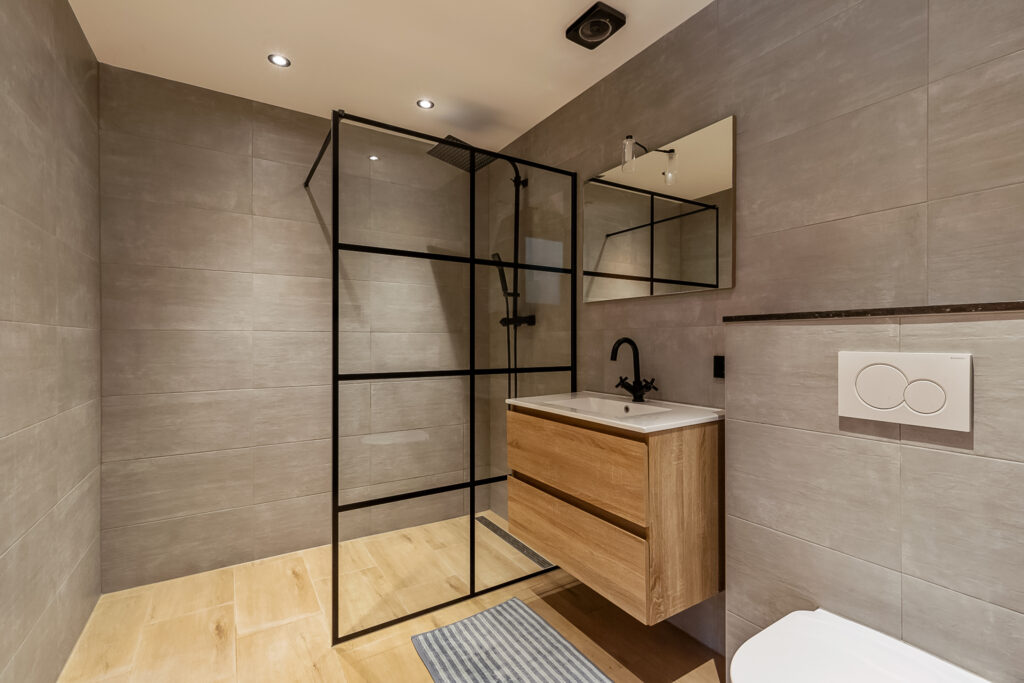 Modern bathroom with glass shower and wood vanity