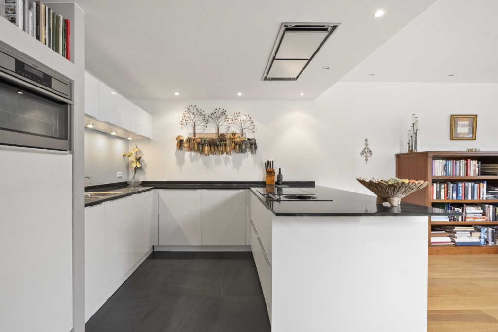Modern kitchen with white cabinets and island.