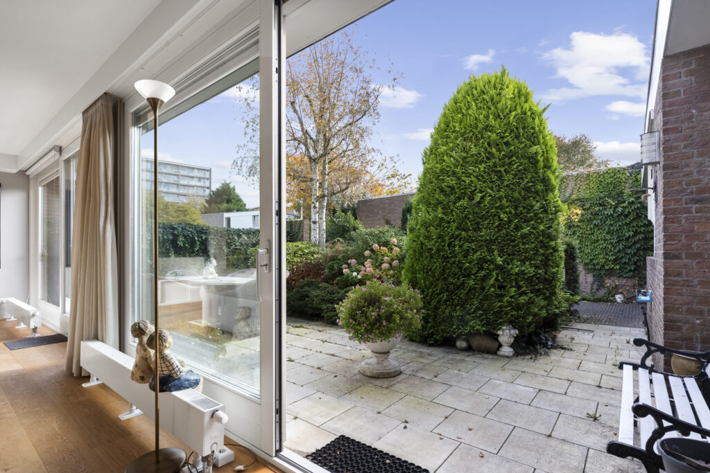 Patio view through open sliding glass door.