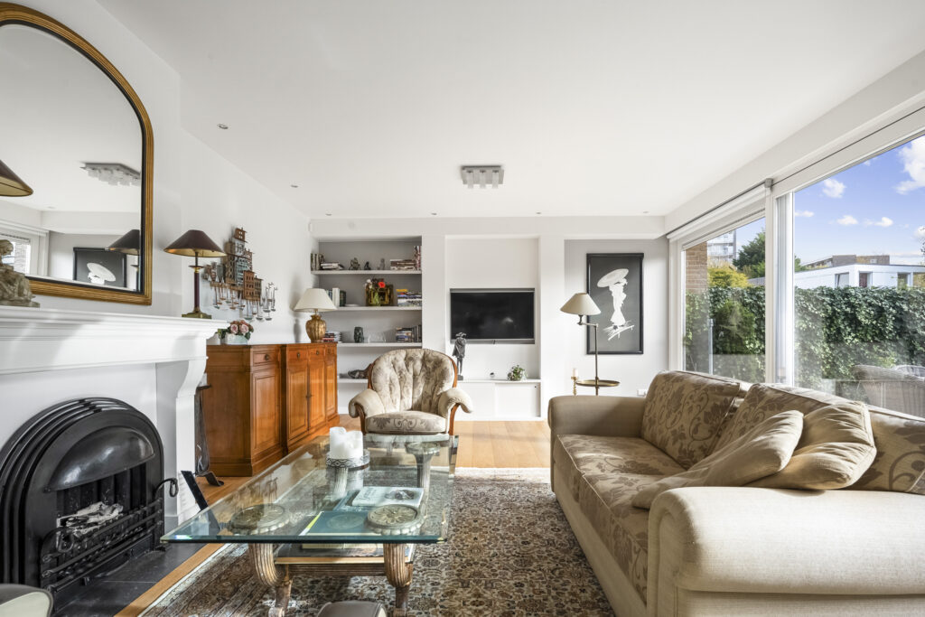 Bright living room with modern decor and large windows.