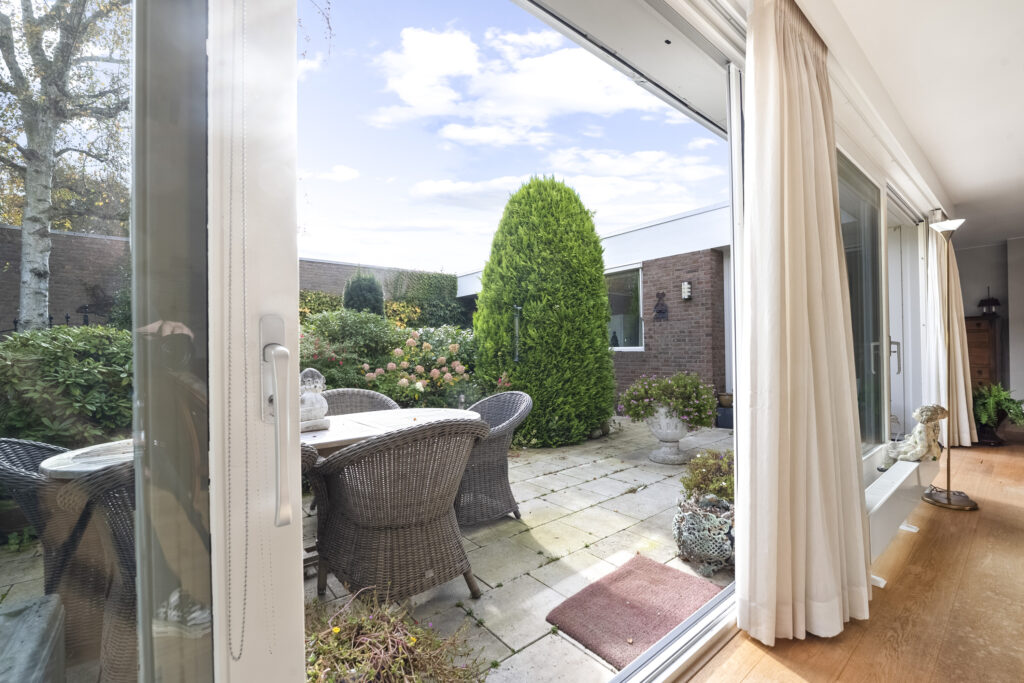Patio view from living room with garden