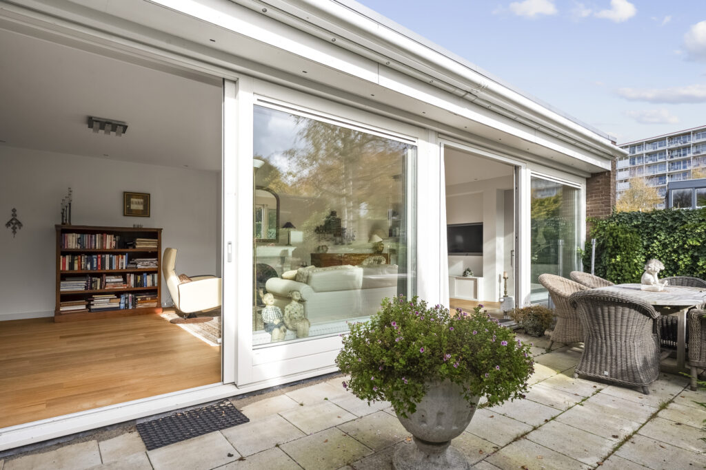 Modern patio with open sliding glass doors.