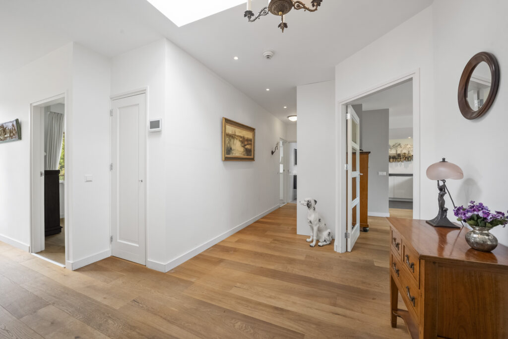 Bright hallway with wooden floors and decor.