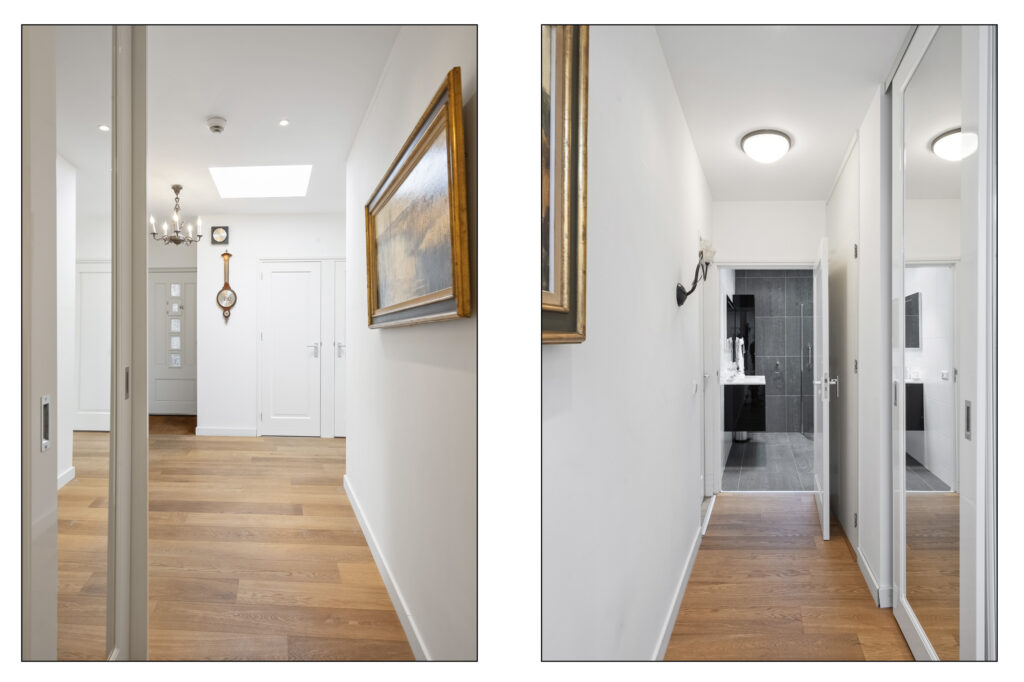 Modern hallway with wooden floors and white walls.