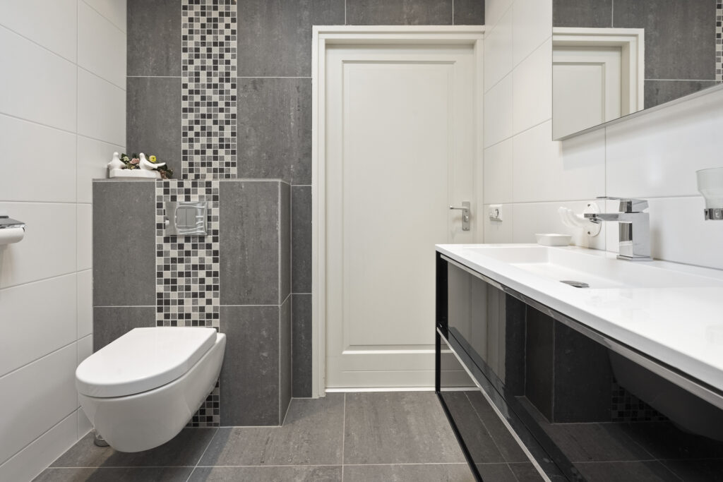 Modern bathroom with sleek design and mosaic tiles.