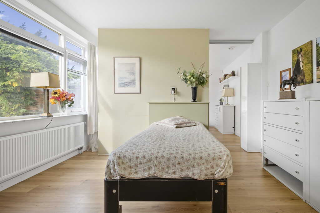 Bright bedroom with single bed and large window