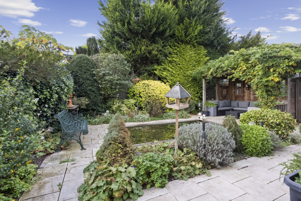 Lush garden with pond and seating area