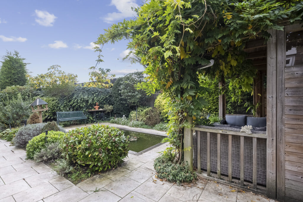 Lush garden with pergola and pond