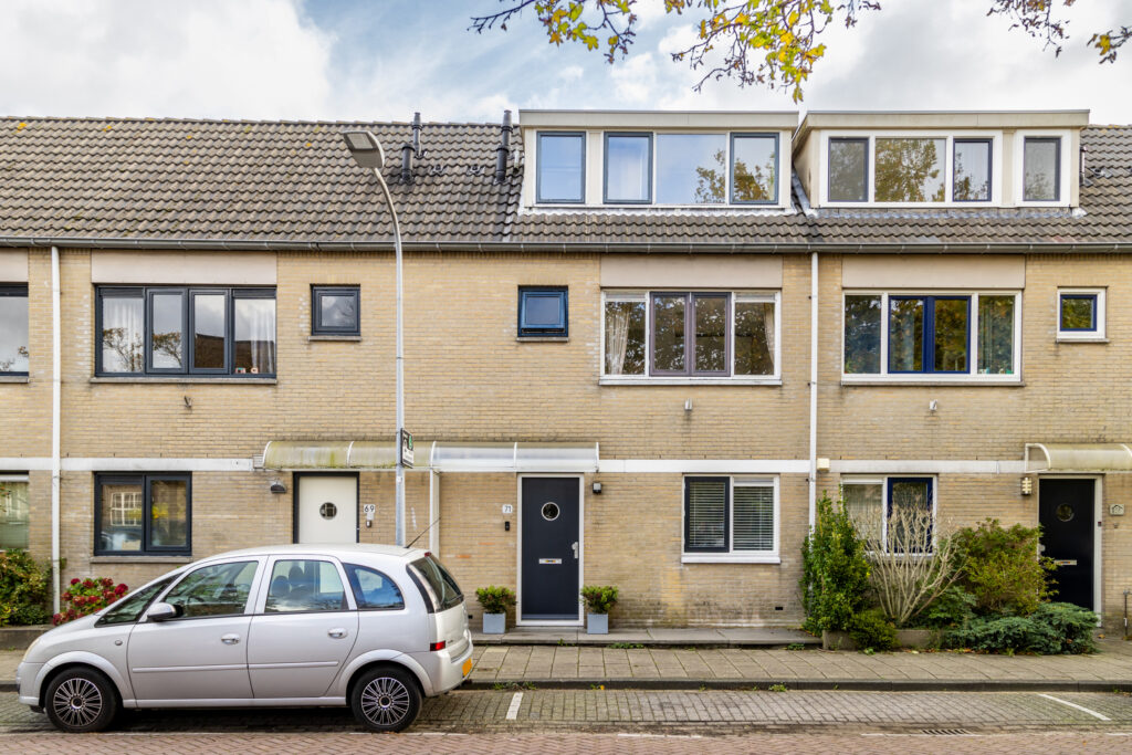 Suburban townhouse with parked car on street