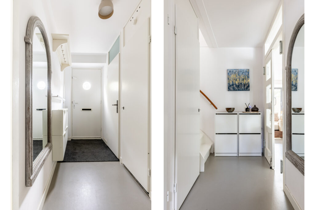 Modern white hallway with mirror and storage cabinets.