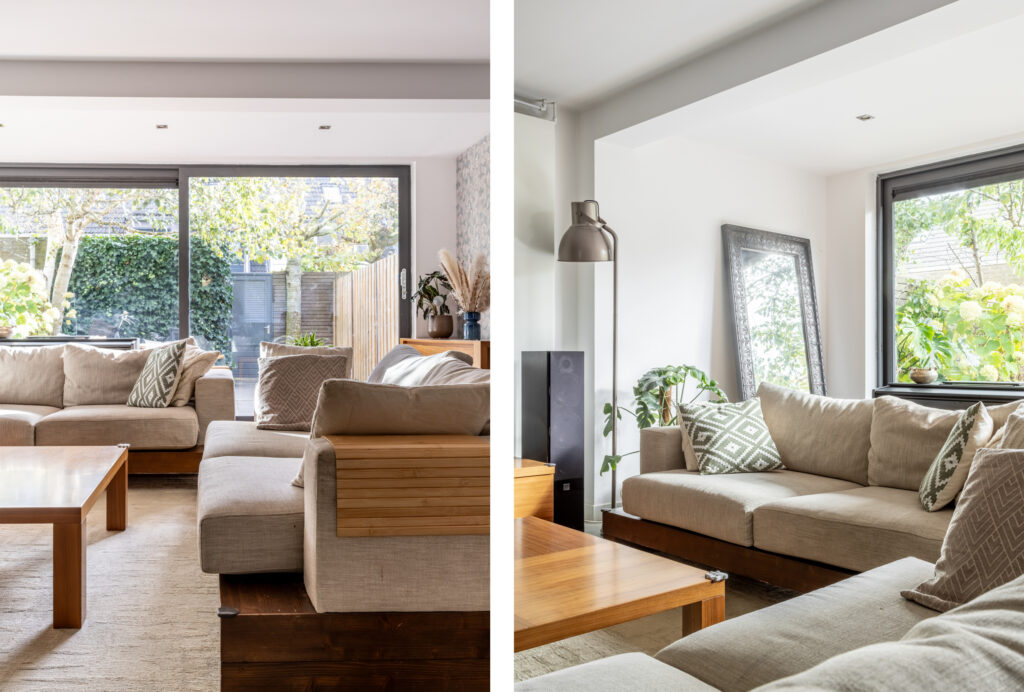 Modern living room with large windows and sofas.