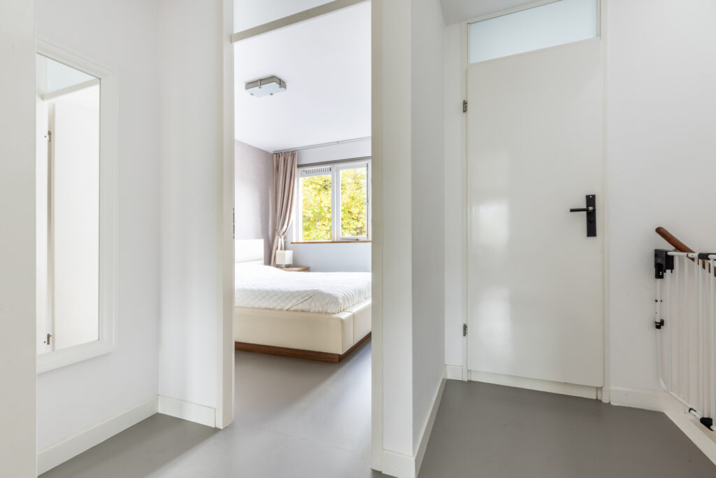 Modern bedroom with open door view