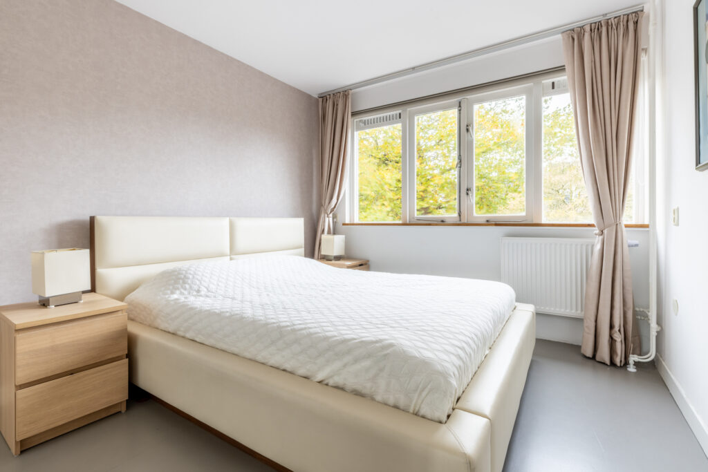 Minimalist bedroom with bed and large window