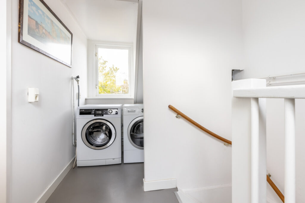 Home laundry room with washer and dryer set.