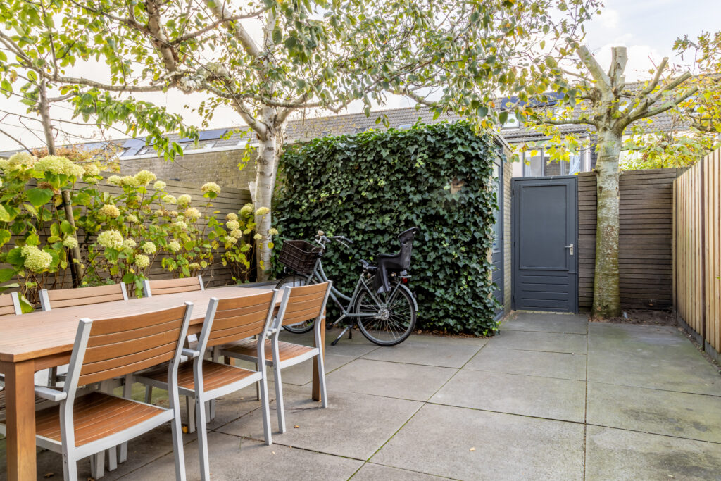 Cozy backyard with table, chairs, and bicycle.