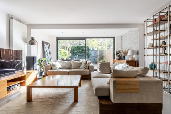 Bright modern living room with large window and sofas.