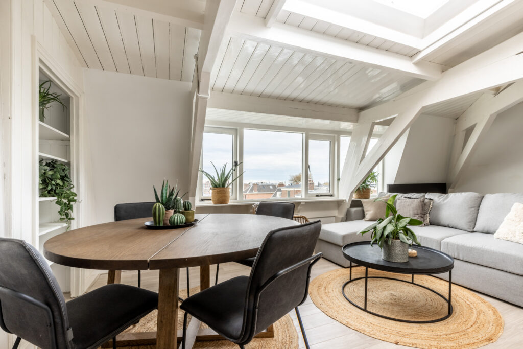 Modern living room with dining table and plants.