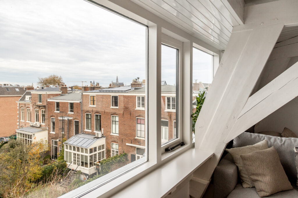 Historic brick buildings viewed from a cozy attic window.
