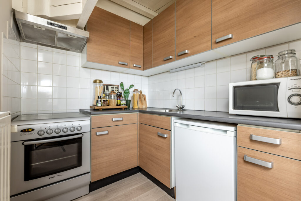 Modern kitchen with wooden cabinets and appliances.