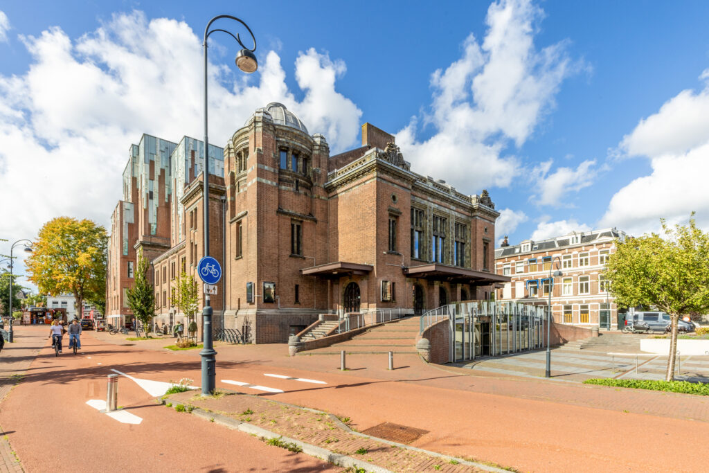 Historic brick building with cyclists on path