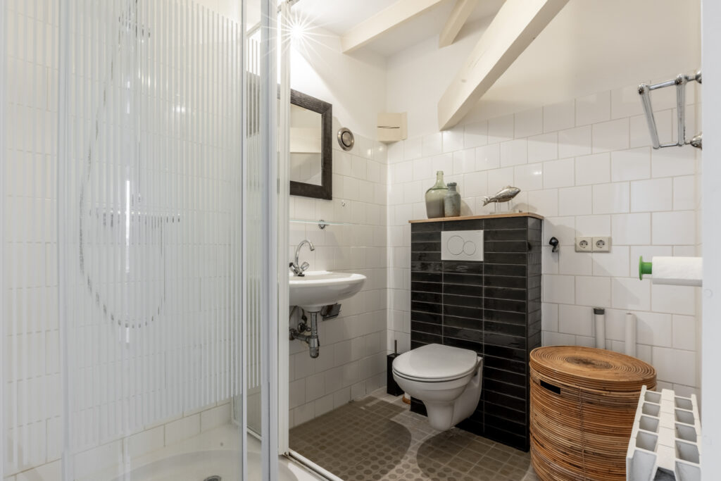 Modern bathroom with shower, sink, and toilet.