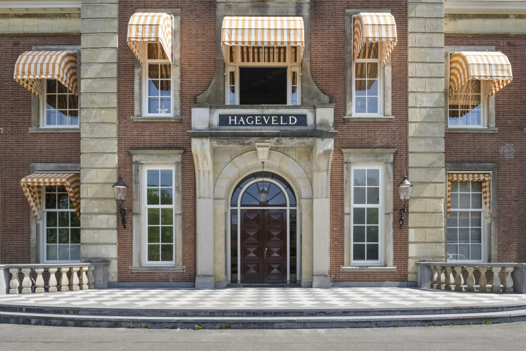 Historic building entrance with striped awnings.